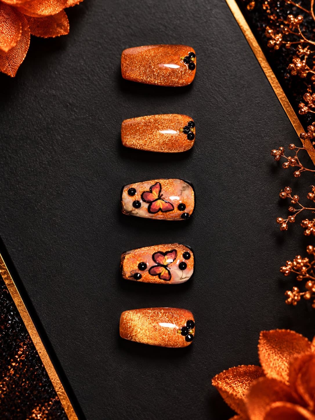 Copper cat-eye press-ons with painted monarch butterflies